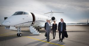 Business people with private jet on the background