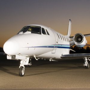 Private jet parked on runway at dusk